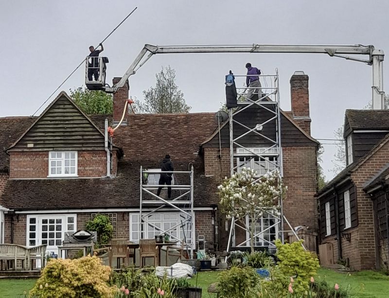 The Moss Cleaners using cherry picker and scaffolding to clean roof safely and professionally in Bromley, {{COUNTY}}
